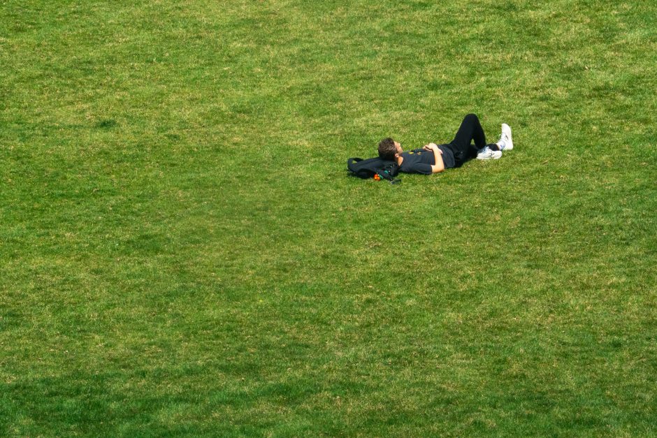A student lying in the grass
