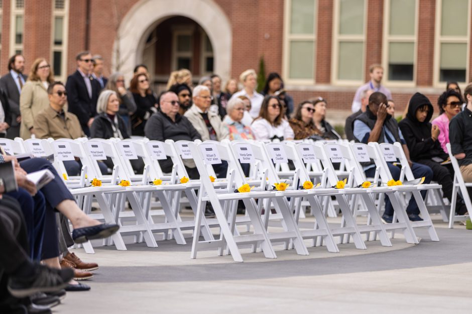White chairs with yellow roses on the seats