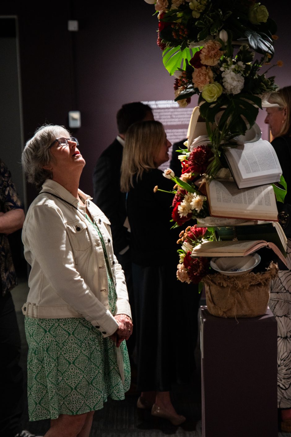 Person looking up at a piece of art