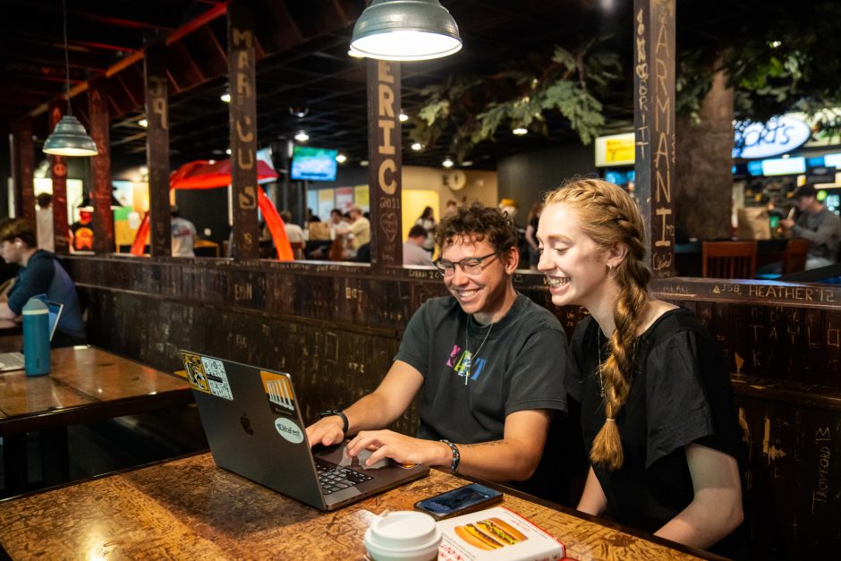 Two students looking at a laptop