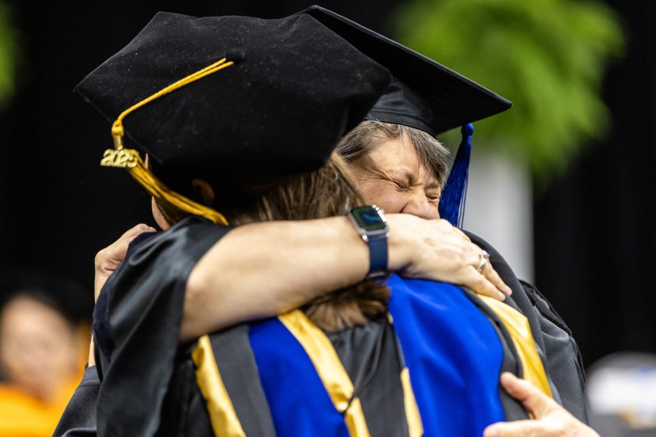 Graduates hugging each other