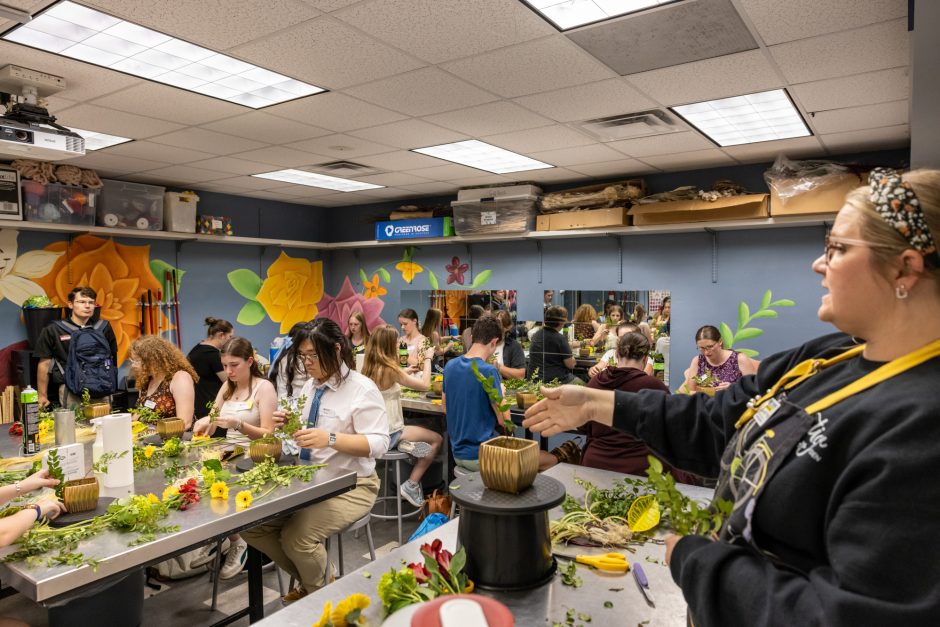 Class of students working on flower arrangements