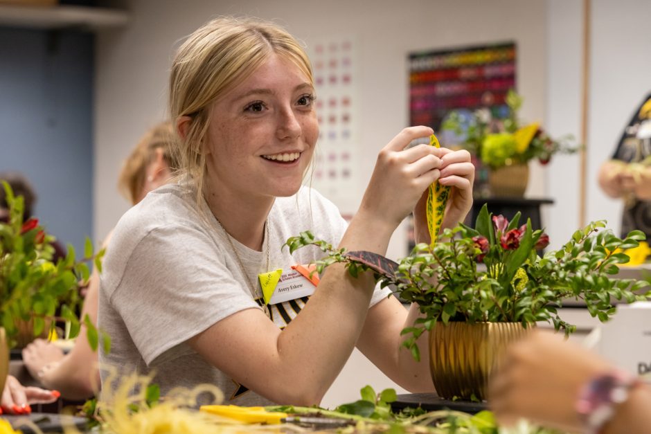 Student making a flower arrangement