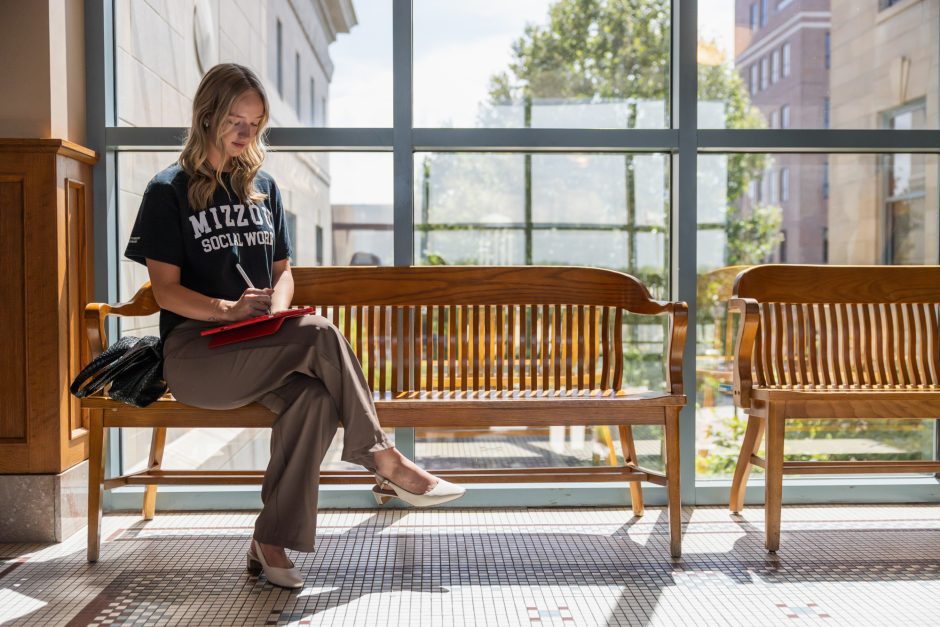 Social work student sitting on a bench
