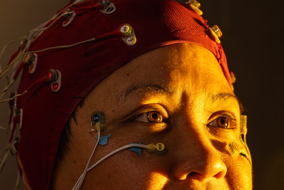 Person with sensors attached to the head and face