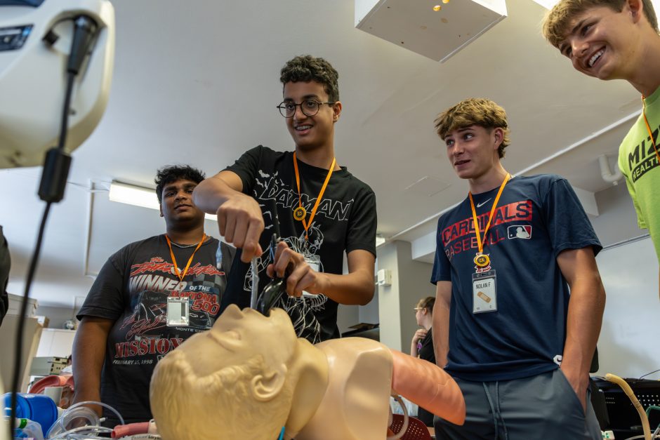 Students working on a medical manikin