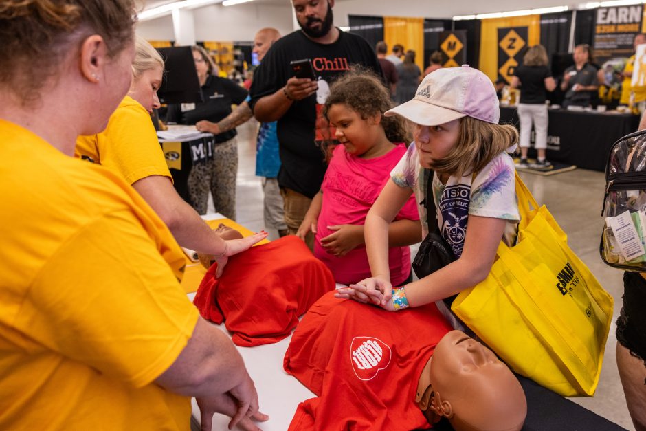 Young person practices CPR on medical manikin