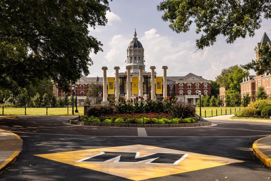 M painted on the pavement with the Columns and Jesse Hall in the background