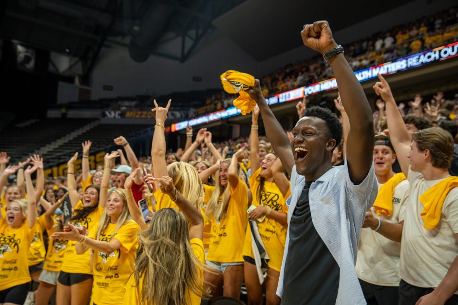 Students with arms raised in celebration