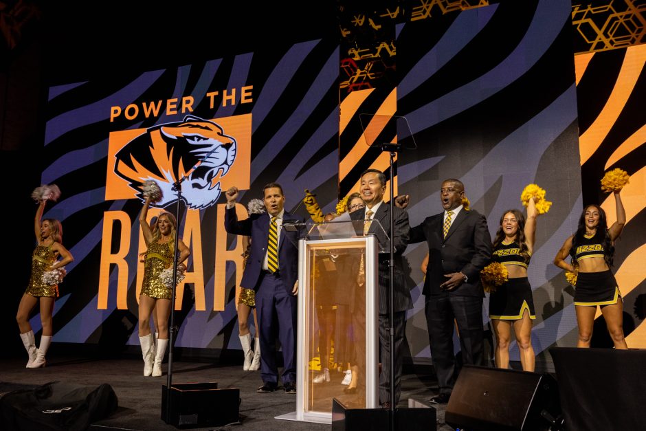 University president and other leaders on stage