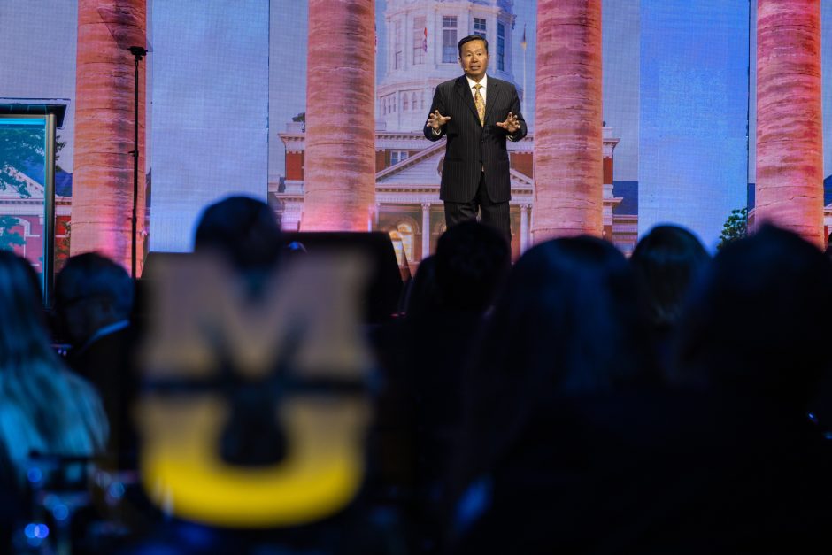 University president speaking on stage