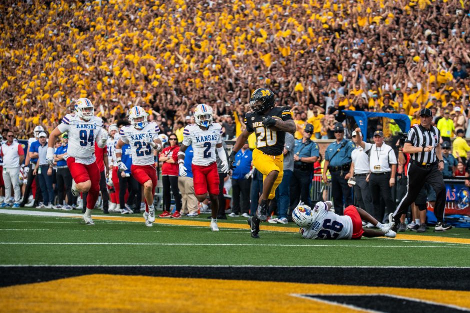 Football player being chased by opposing team