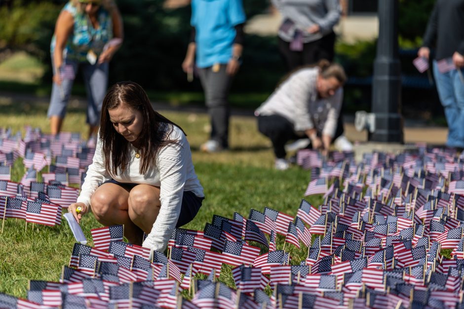 Person planting small American flags