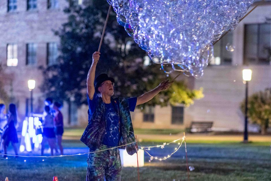 Person reaching up toward a glowing shape