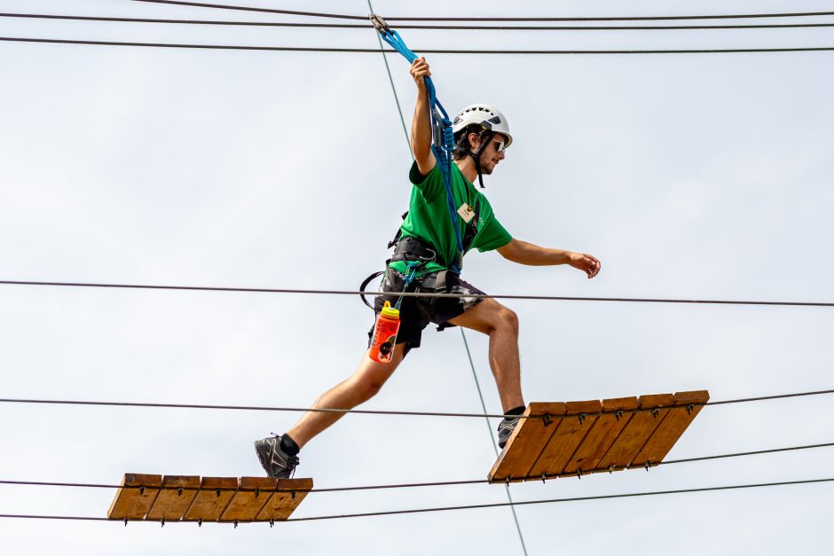 Student traversing elevated ropes course