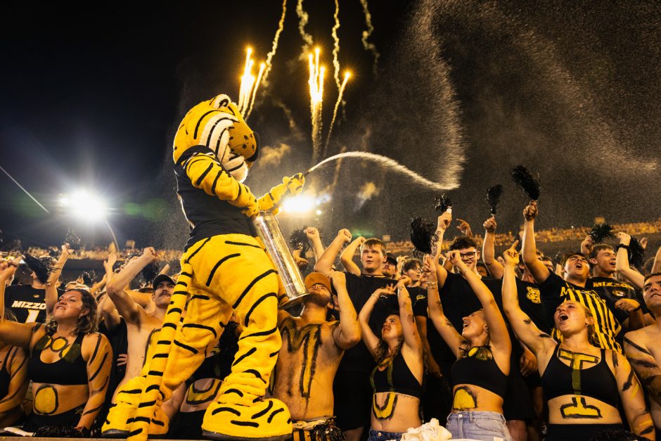 Truman the Tiger spraying water over the student section as fireworks go off