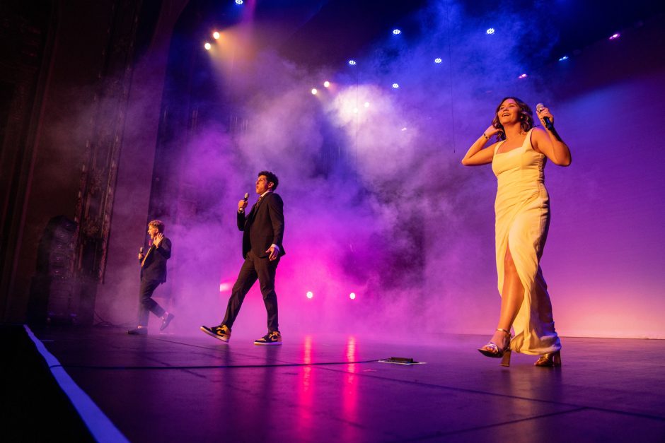 Smoke-filled stage as three performers are on stage
