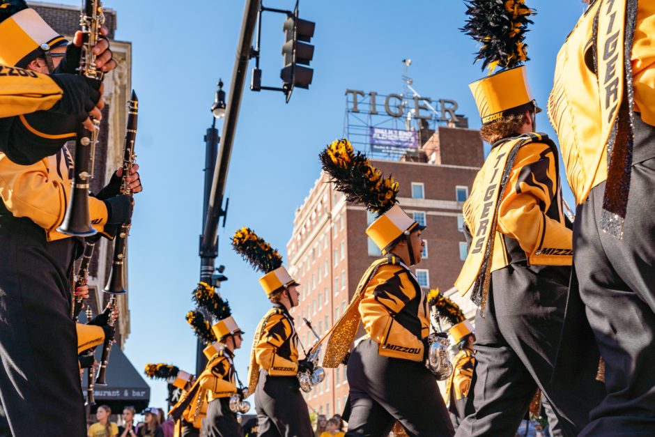 Marching Mizzou members marching in front of Tiger Hotel