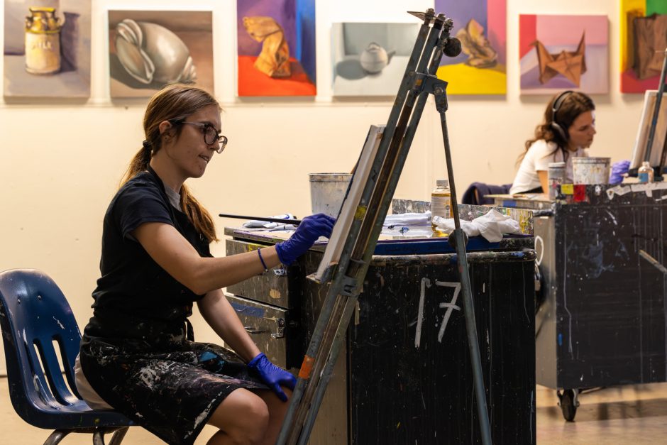 Student painting at a easel