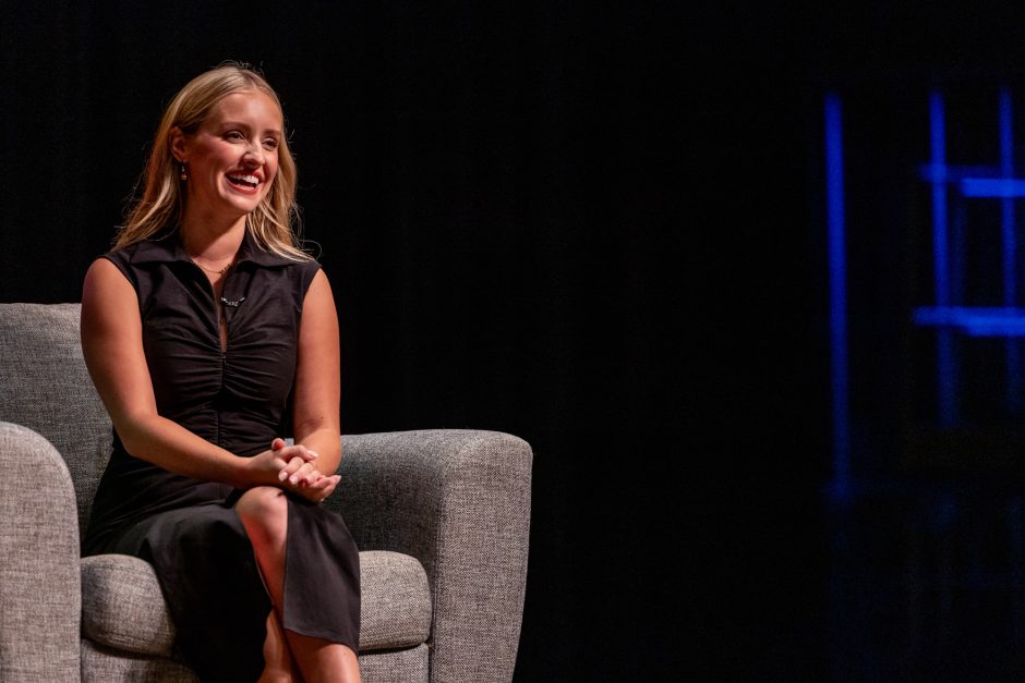 Person sitting in a chair on a stage