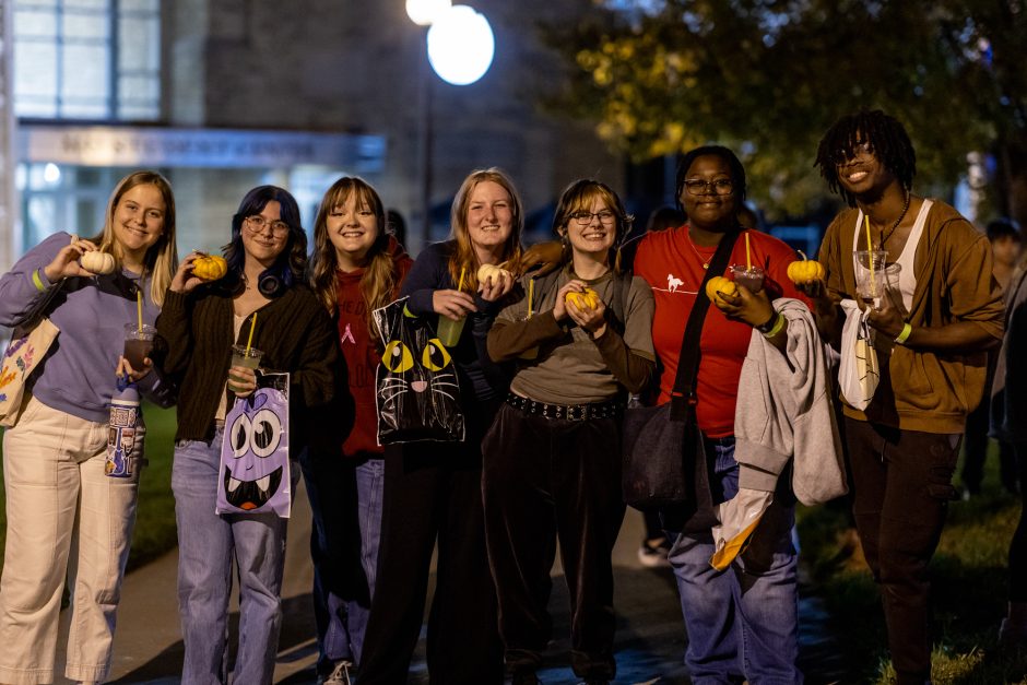 Group of student holding small pumpkins