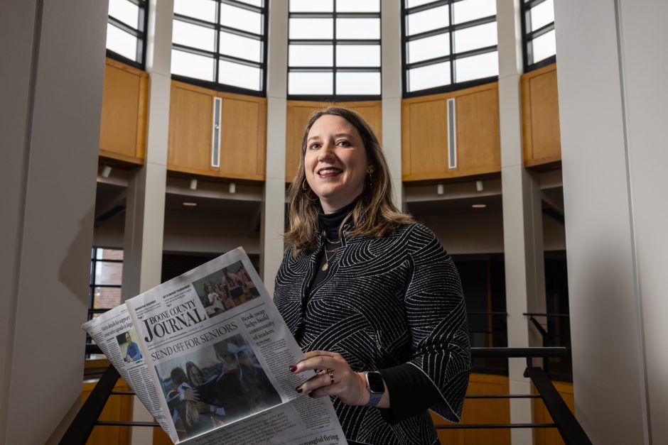 Person holding an open newspaper