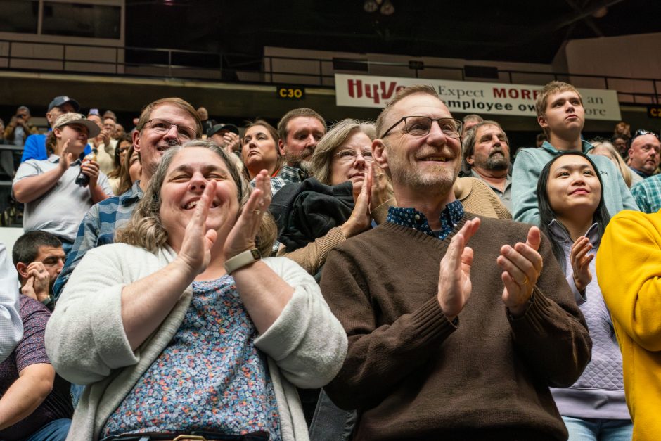 Members of graduation ceremony audience clapping