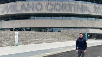 Kimber Auerbach in front of the hockey arena at the 2026 Winter Olympics