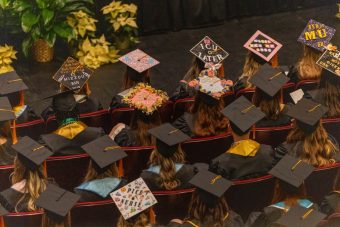 large group of graduates in caps and gowns