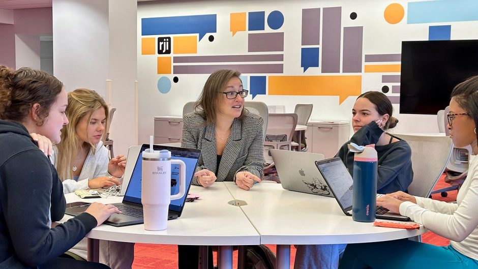 Amy Simons with students at table