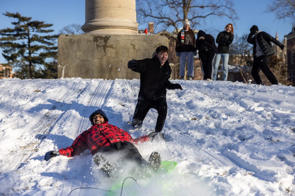 Students sledding outside in the snow