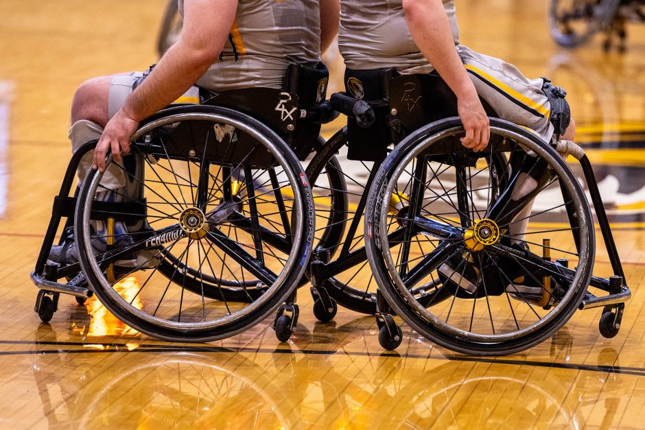 Two basketball players in wheelchairs back to back