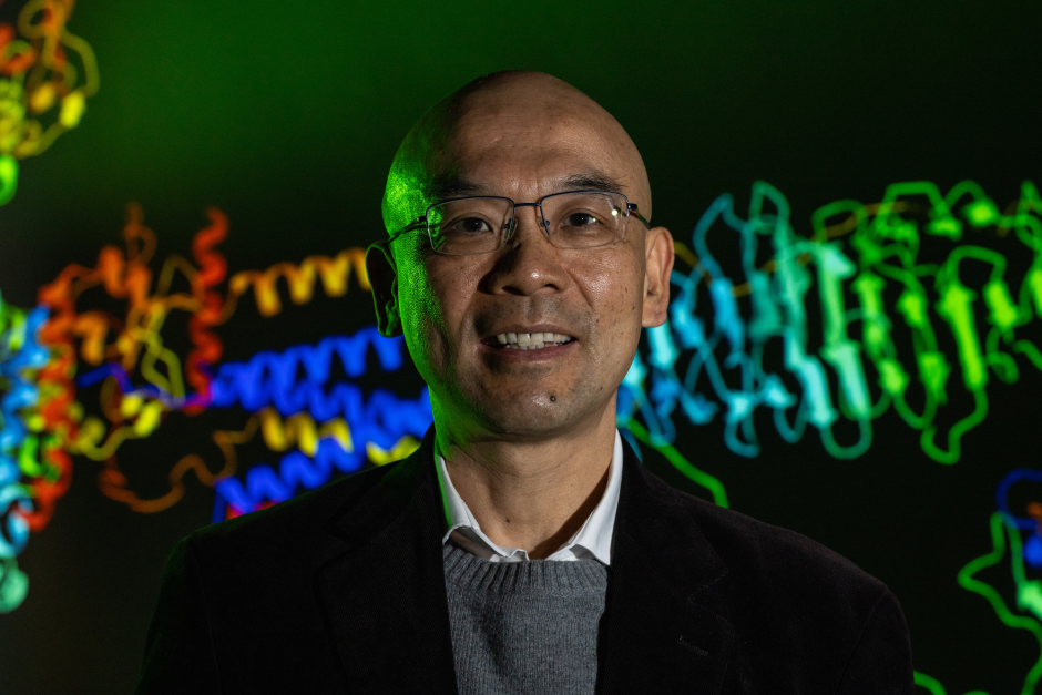 Jack Cheng portrait with a protein structure in the background