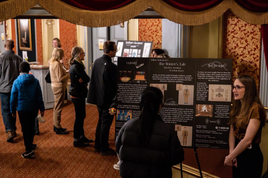 Crowd members view art displays