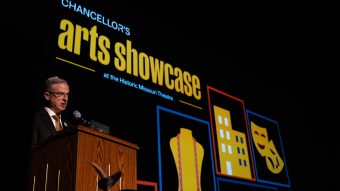 Person speaking at a podium on stage