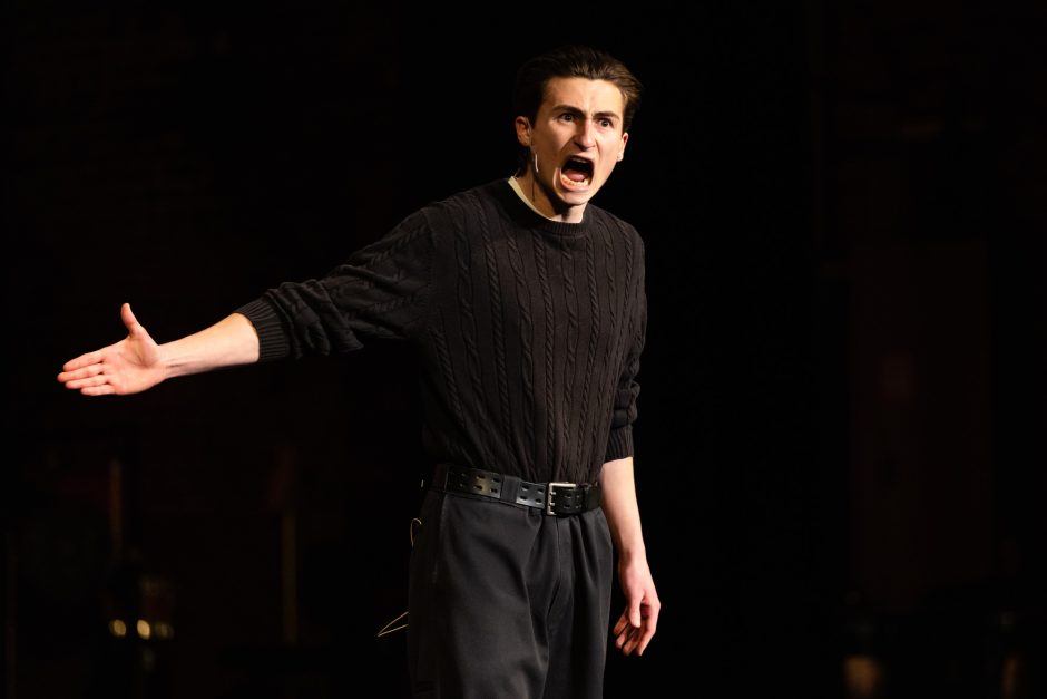 Student performer in all black clothing on stage