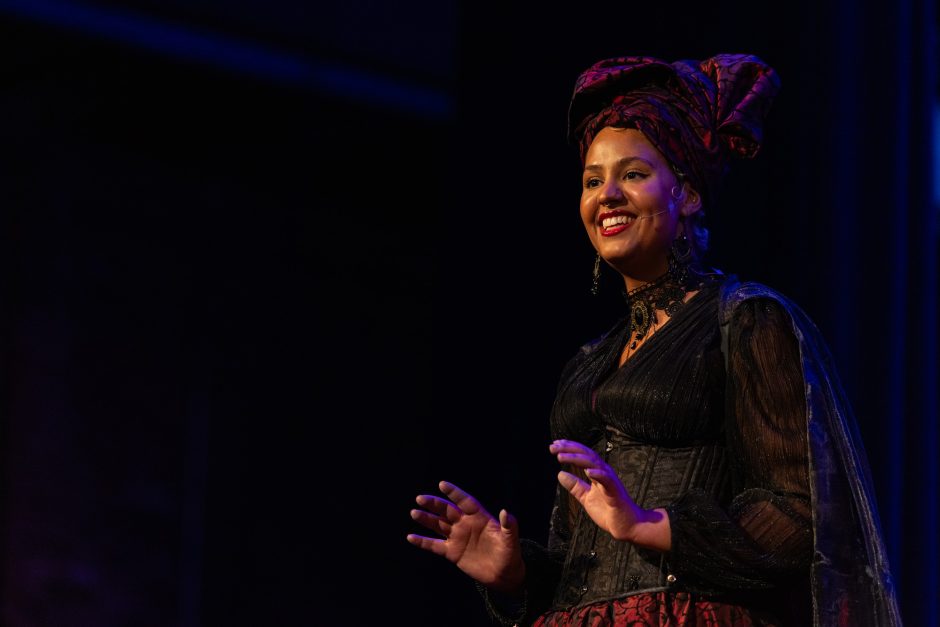 Student performer in a formal gown on stage