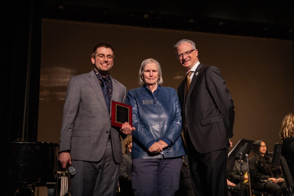 Student award winner with two university officials