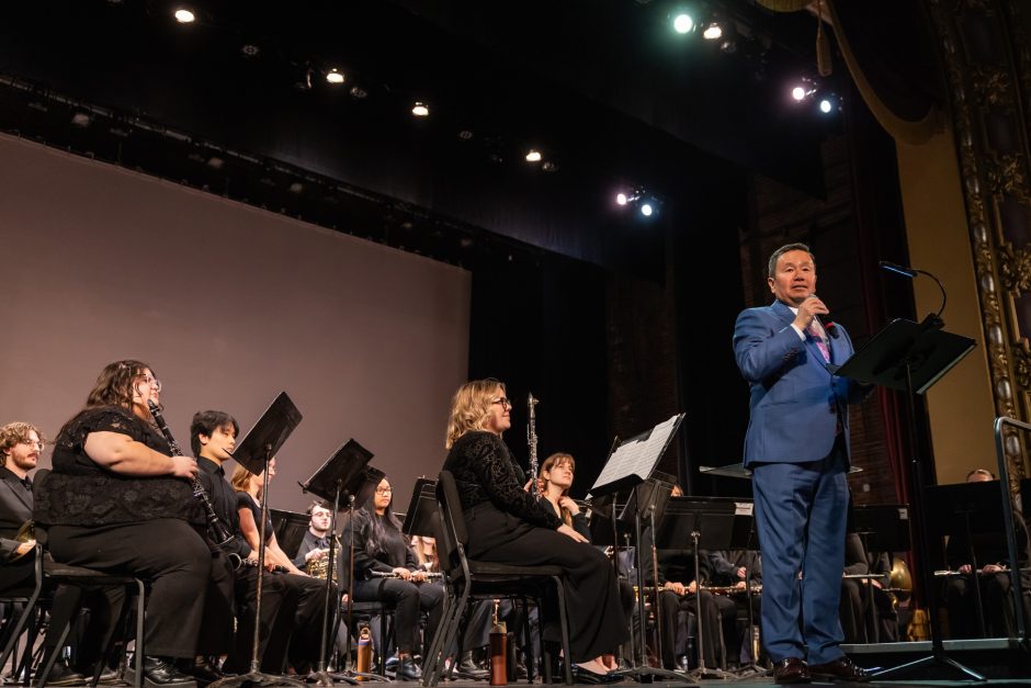 Person on stage talking into a microphone