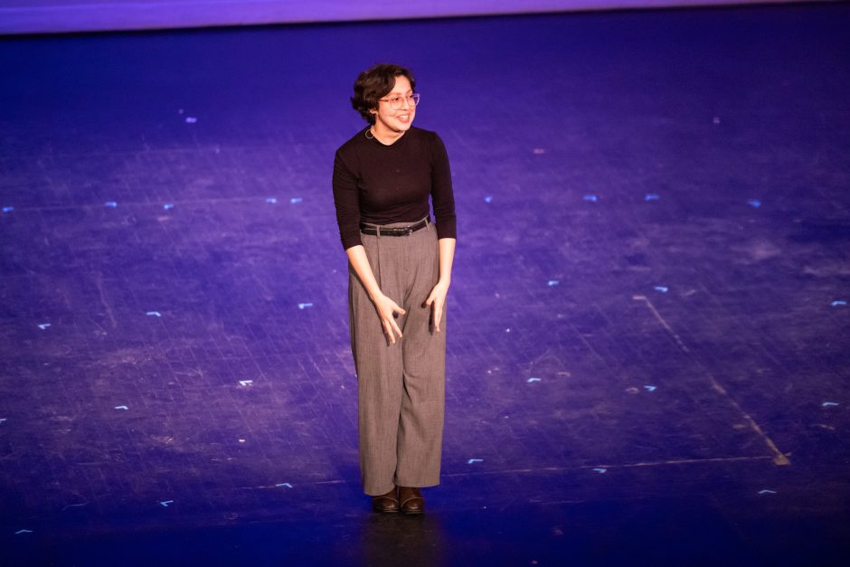 Student standing on stage during a performance
