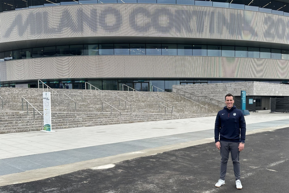 Kimber Auerbach in front of the hockey arena at the 2026 Winter Olympics