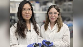 Two women in lab hold biochar