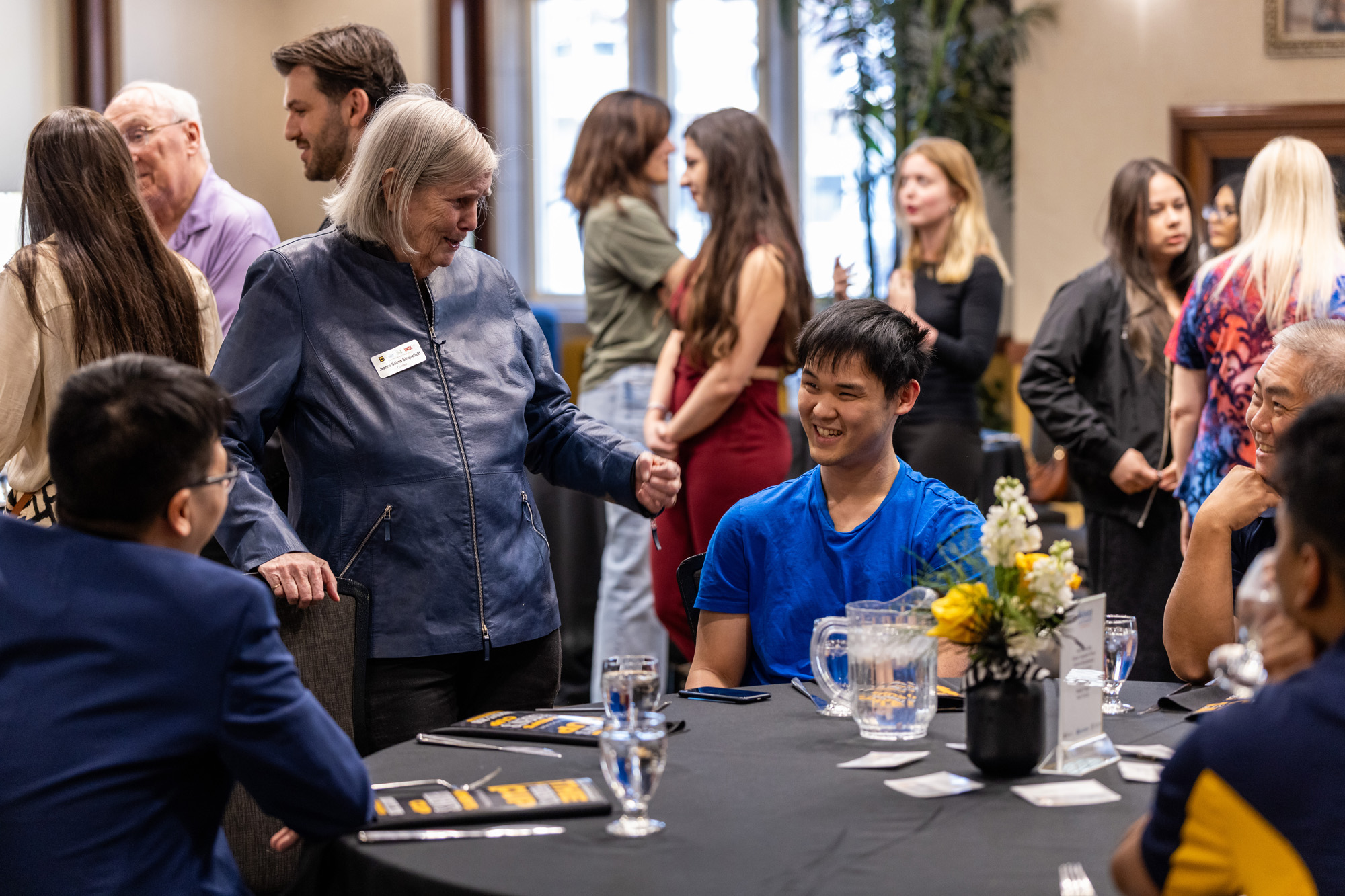 People gather around chess table