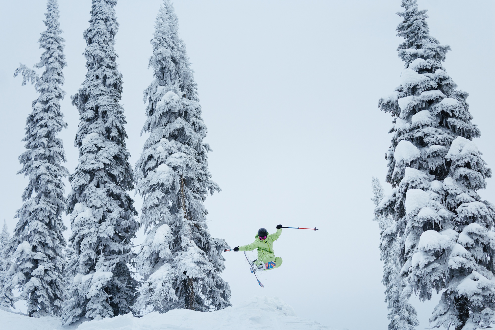Erin Spong catches air while skiing down a snow-covered mountain