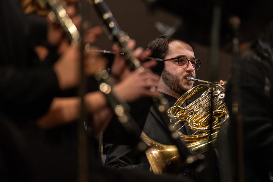 Student musician playing the French horn
