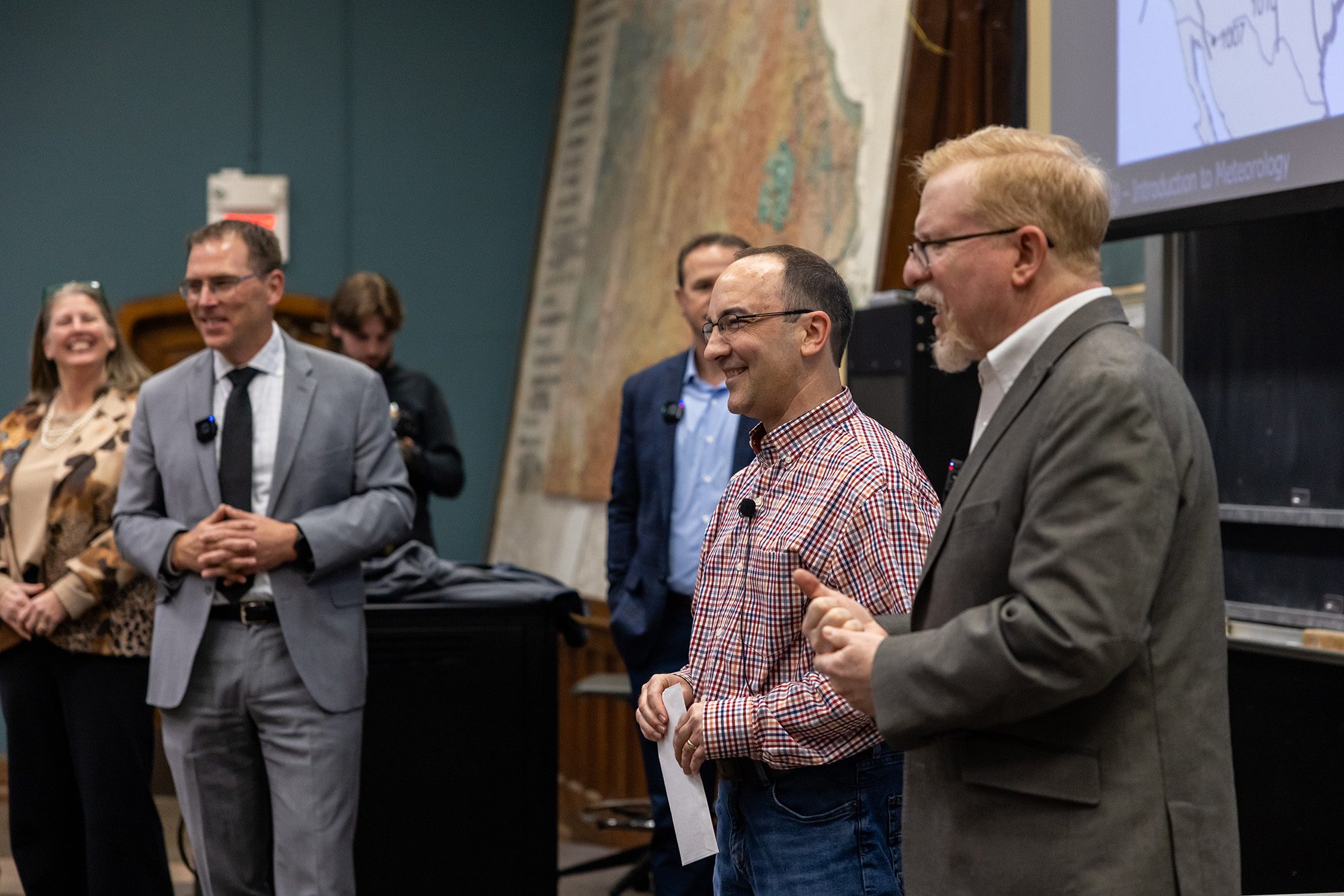 Professor and guests at front of classroom