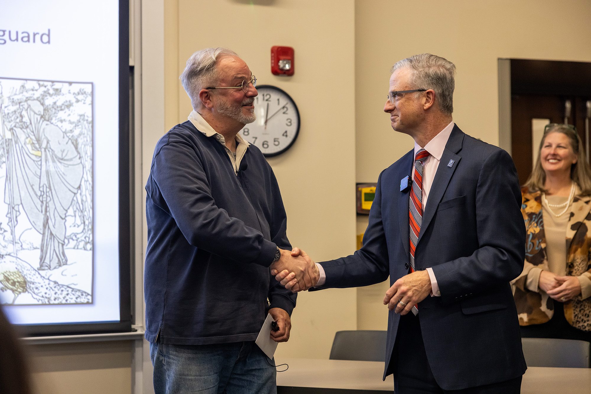 Professor shaking hands with dean
