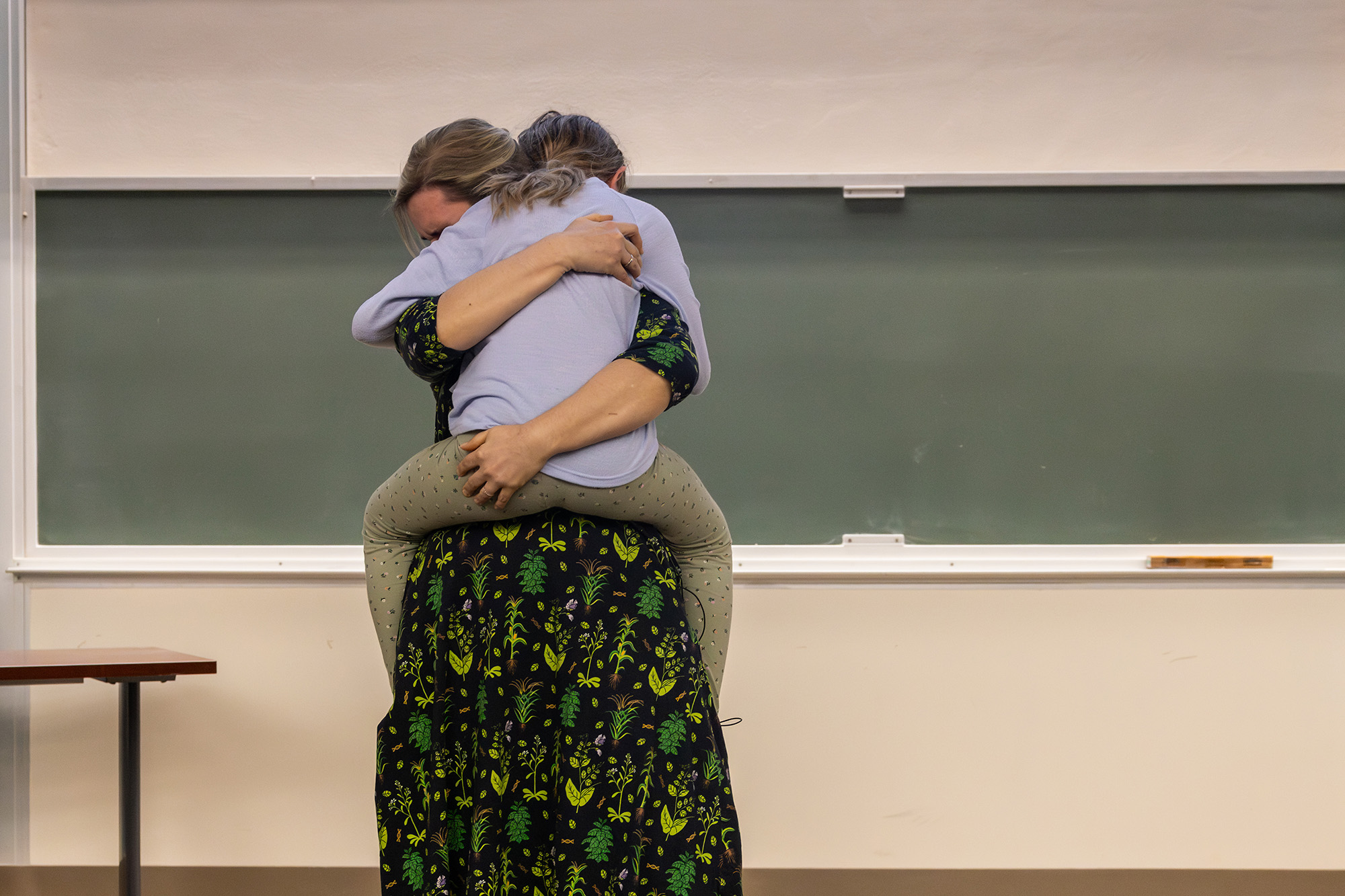 Professor holding a child in giant hug