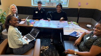 Students collaborate around a table