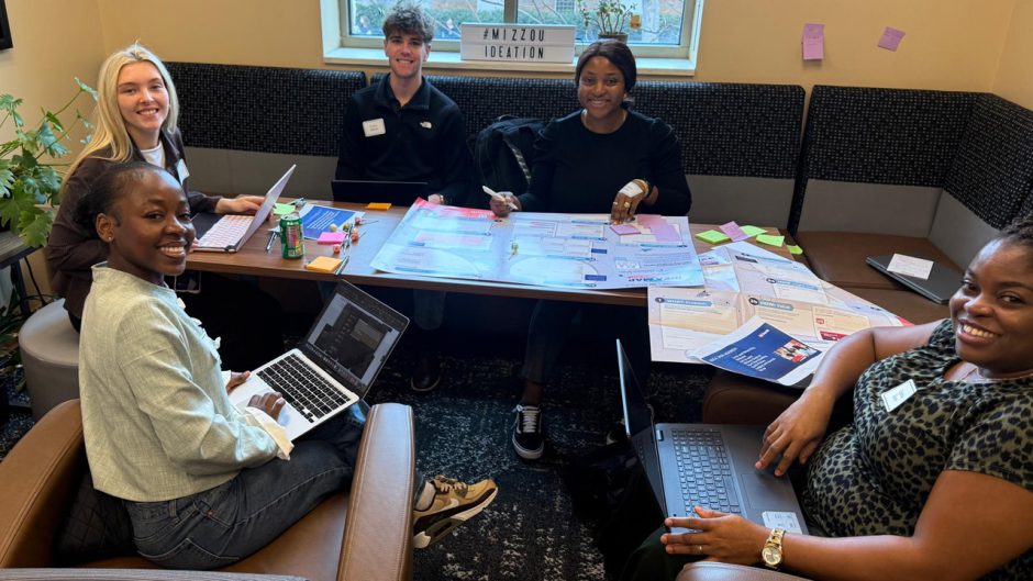 Students collaborate around a table